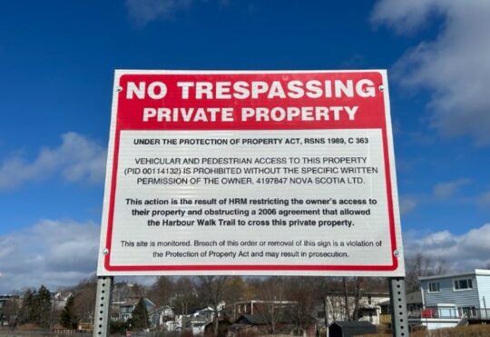 Company pushing to infill Dartmouth Cove puts up no trespassing signs